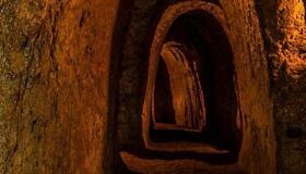 Iconic Cu Chi underground network for a vibrant Cu Chi Tours banner with Legend Travel Group.